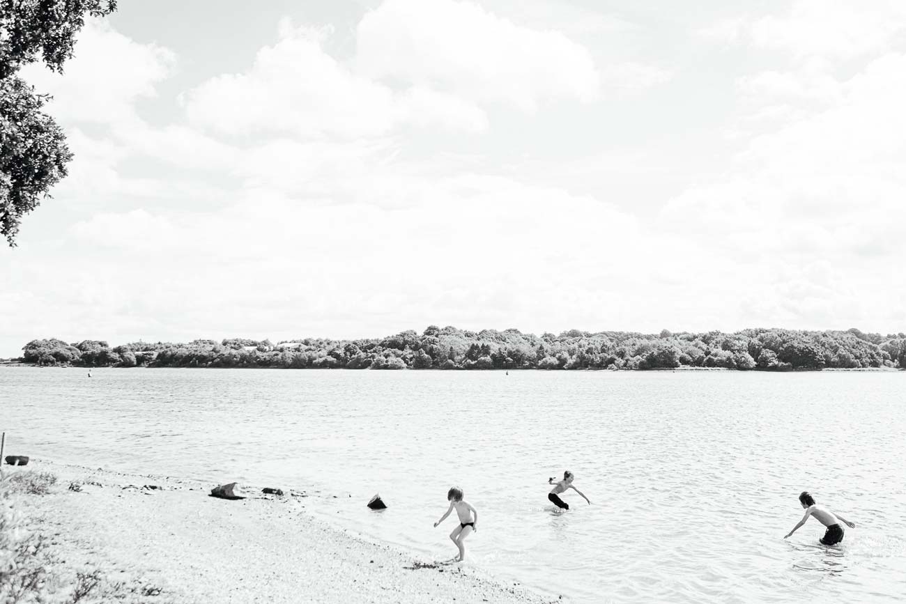 children playing in a lake in summer